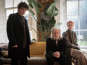 A young man stands over an older couple sitting on a couch in a luxurious house. It's a still from the new movie '& Sons' - and SWITCH is giving you the chance to win a double pass!