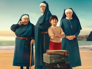 Three nuns and a young boy stand in front of a suitcase. It's a still from the new film 'Holy Days' - and SWITCH is giving you a chance to win one of five double passes!